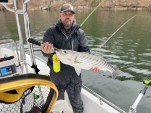 Larry Smith holding striped bass